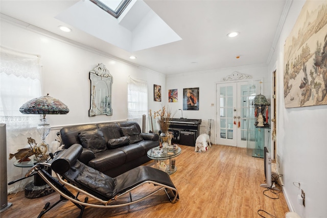 living room with french doors, a skylight, ornamental molding, and wood-type flooring