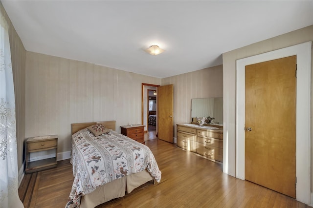 bedroom with wood-type flooring