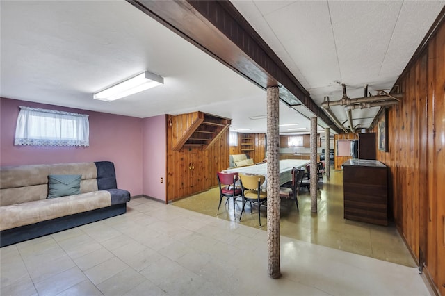 basement featuring wood walls