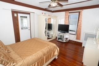 bedroom with ceiling fan and dark hardwood / wood-style flooring