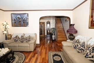 living room featuring dark hardwood / wood-style floors and ornamental molding