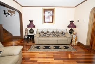 living room with hardwood / wood-style flooring and ornamental molding