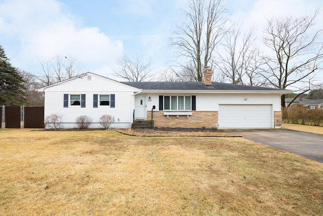 single story home featuring a garage and a front yard