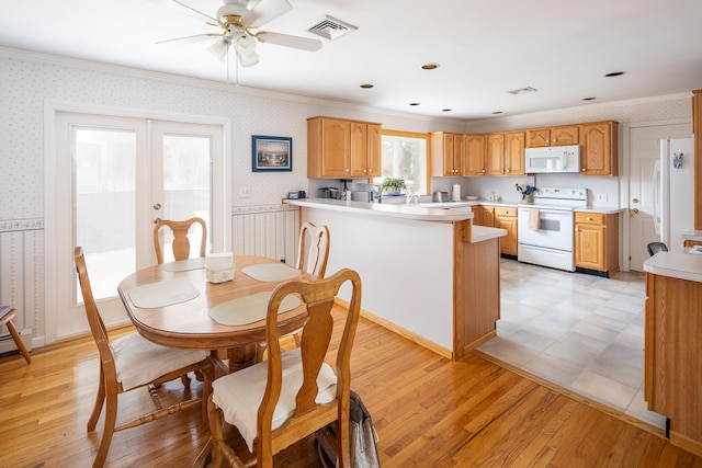 dining space featuring ceiling fan, crown molding, french doors, and light wood-type flooring