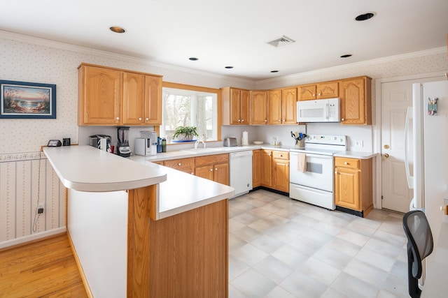 kitchen featuring ornamental molding, sink, kitchen peninsula, and white appliances