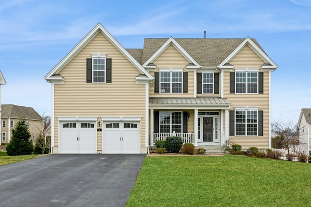 view of front of property with a porch, a front yard, and a garage