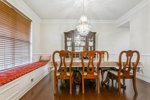 dining space with a notable chandelier, crown molding, and dark hardwood / wood-style flooring