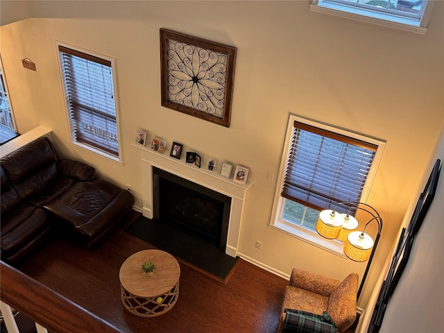 living room with dark wood-type flooring and a healthy amount of sunlight