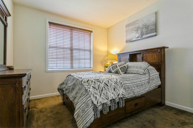 bedroom with dark colored carpet