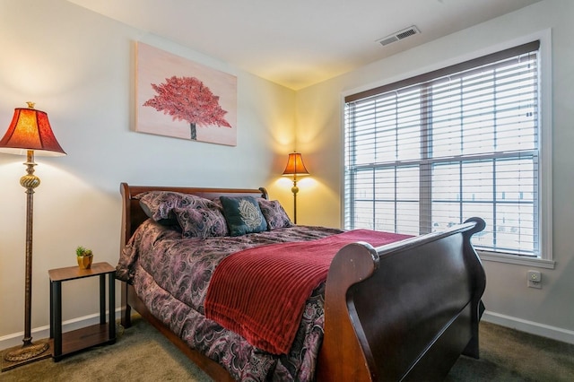 carpeted bedroom with multiple windows