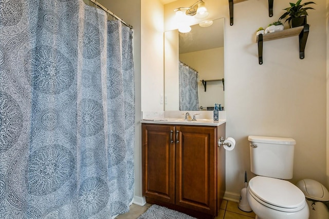 bathroom with toilet, vanity, and tile patterned floors