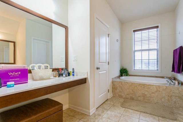 bathroom with tiled bath, tile patterned flooring, and vanity