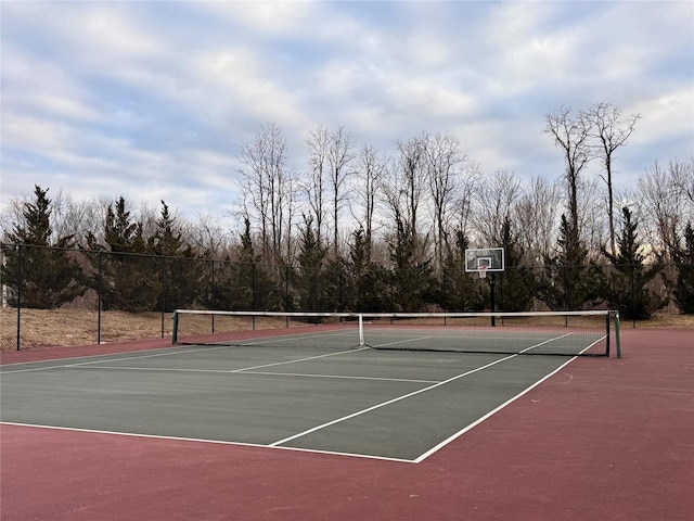 view of tennis court featuring basketball hoop