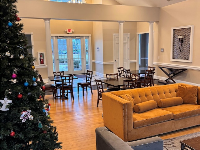 living room featuring decorative columns and wood-type flooring