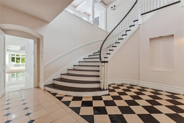 stairway with tile patterned floors