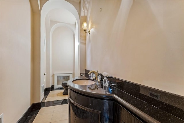 bathroom with tile patterned flooring, vanity, and toilet