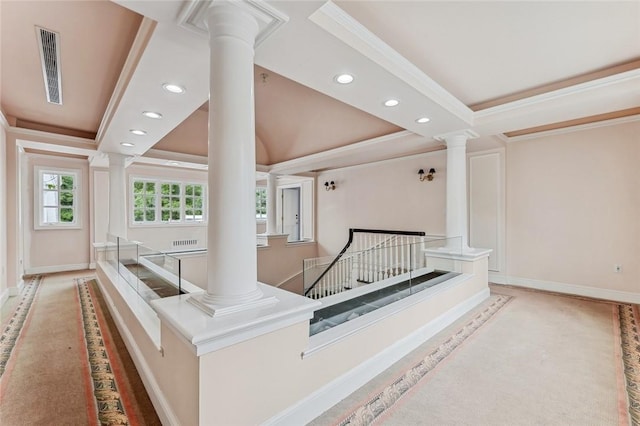 interior space featuring a raised ceiling and ornamental molding