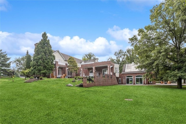 rear view of property featuring a yard