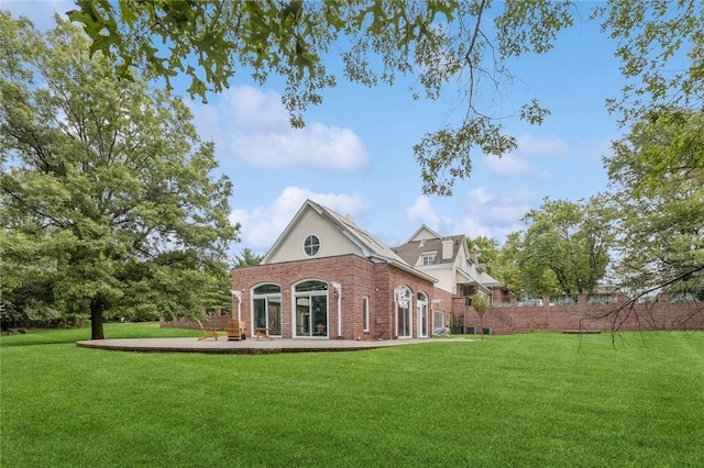 rear view of house with a yard