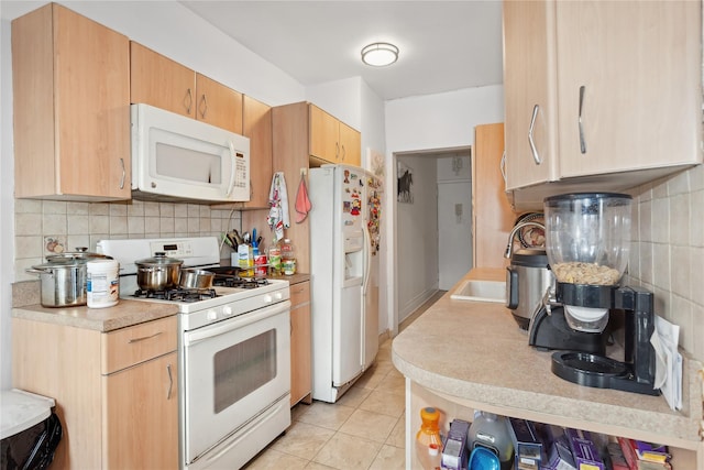 kitchen with light brown cabinetry, backsplash, white appliances, sink, and light tile patterned flooring