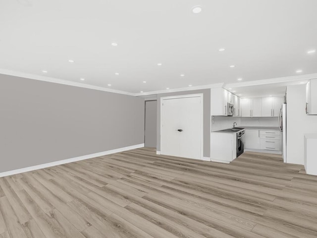 unfurnished living room with light wood-type flooring and ornamental molding