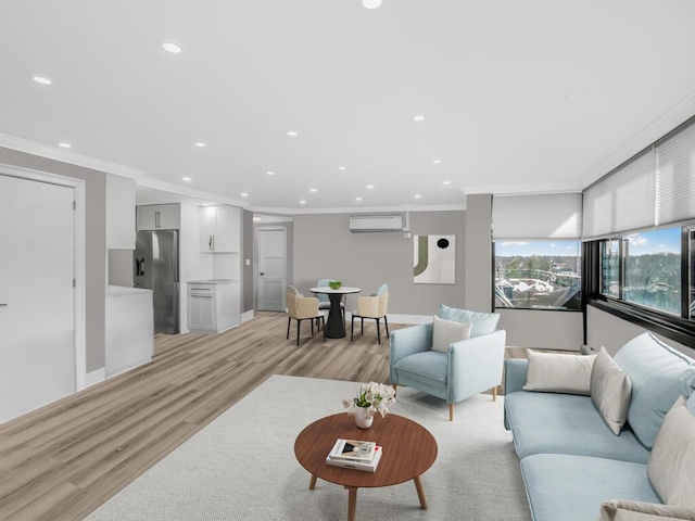 living room with a wall mounted air conditioner, light wood-type flooring, and crown molding