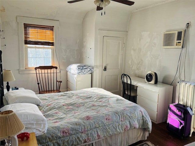 bedroom featuring dark wood-type flooring, radiator, vaulted ceiling, ceiling fan, and a wall mounted AC