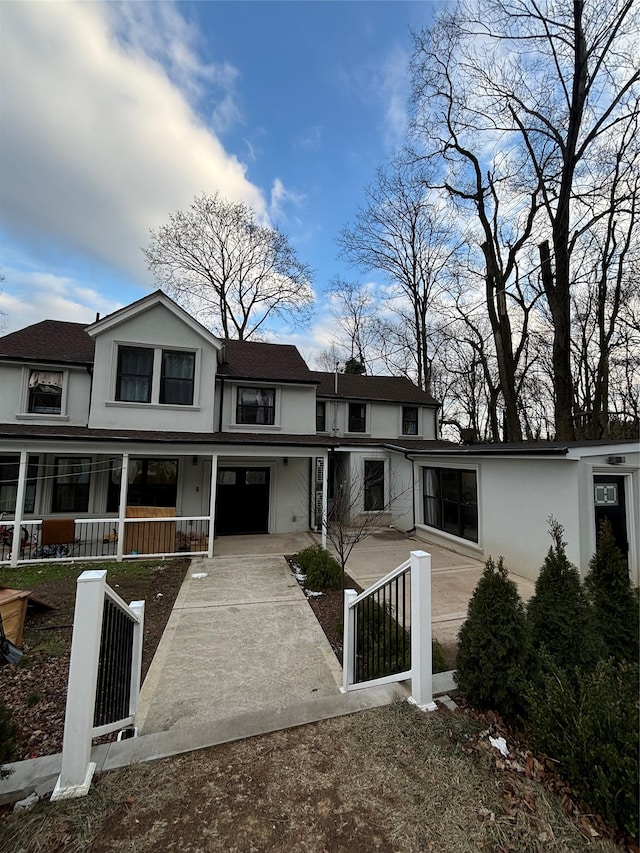 back of property featuring covered porch