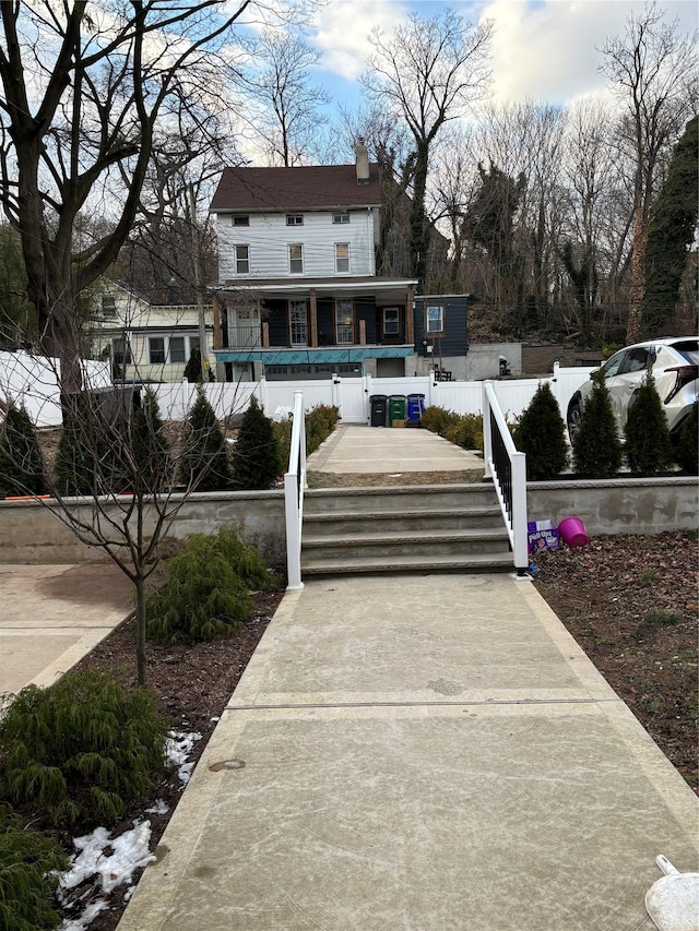 rear view of property featuring a porch