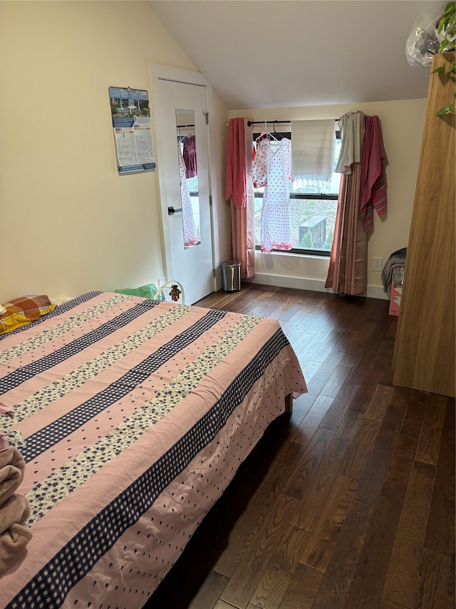 bedroom featuring lofted ceiling and dark wood-type flooring