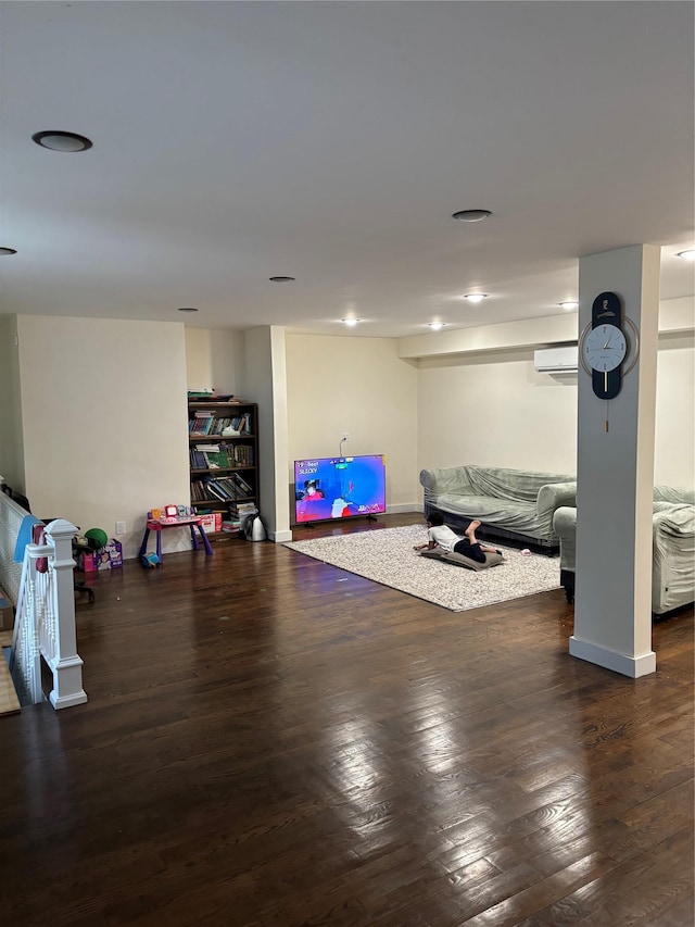 workout area with an AC wall unit and dark wood-type flooring