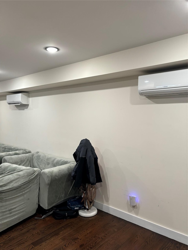 interior space featuring dark hardwood / wood-style flooring and an AC wall unit