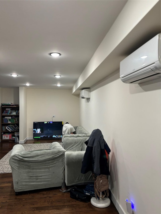 living room featuring an AC wall unit and dark wood-type flooring