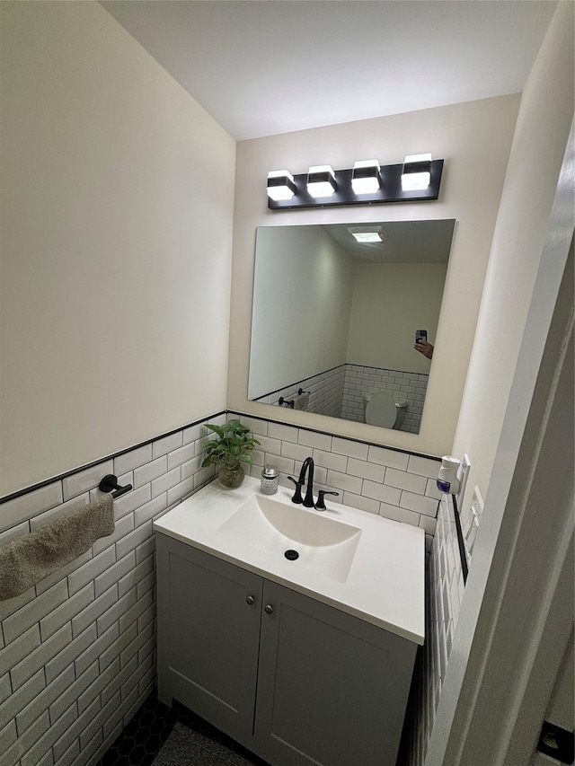 bathroom with vanity, tile patterned floors, and tile walls