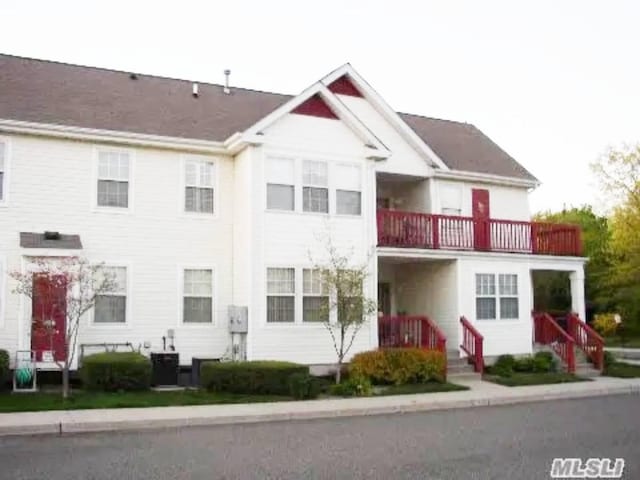 view of front of home with a balcony and cooling unit