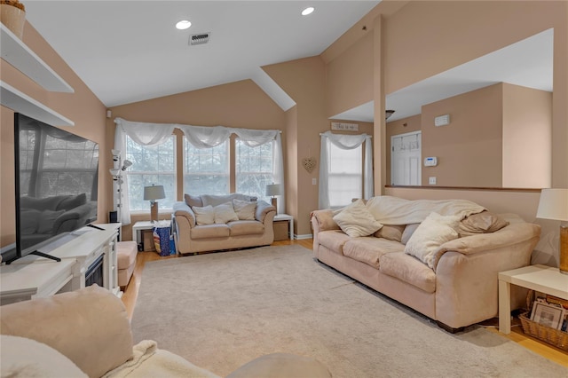 living room with vaulted ceiling and light hardwood / wood-style floors