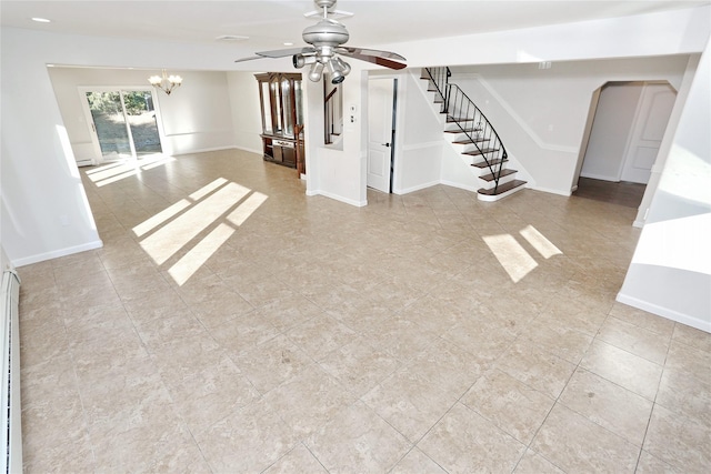 unfurnished living room with ceiling fan with notable chandelier