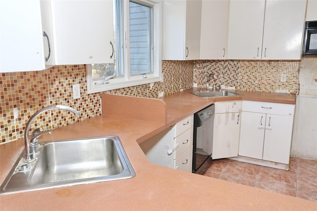 kitchen with black appliances, white cabinetry, and sink