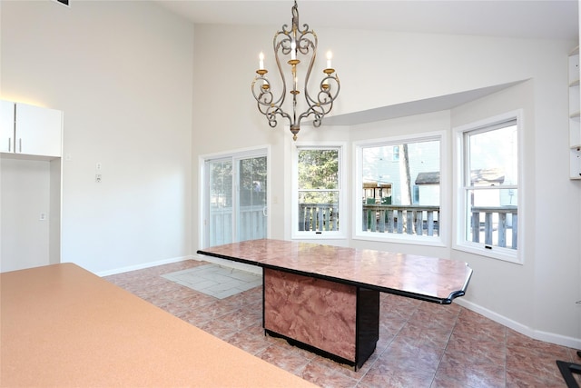 tiled dining area featuring high vaulted ceiling and a notable chandelier