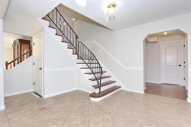 staircase with tile patterned floors