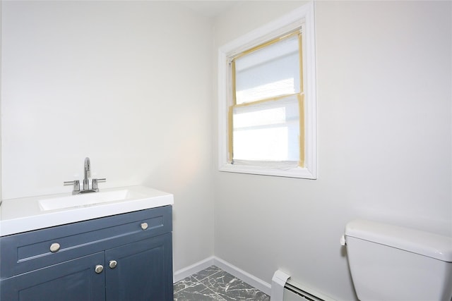 bathroom with vanity, a baseboard heating unit, and toilet