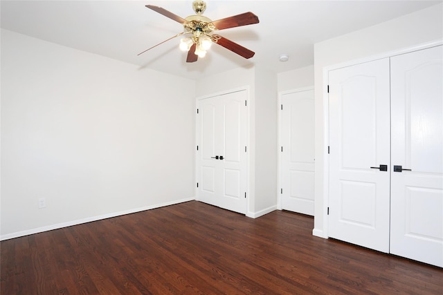 unfurnished bedroom with ceiling fan and dark hardwood / wood-style floors