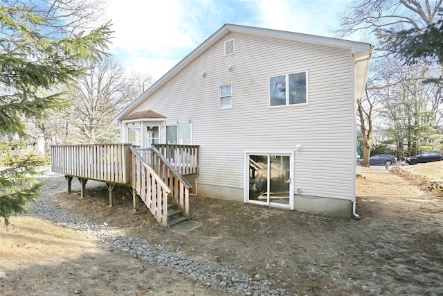 back of property with a wooden deck