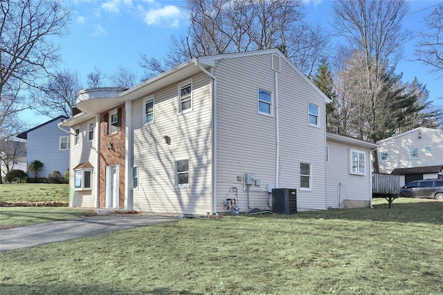 view of property exterior featuring a yard and central AC unit