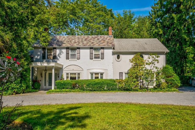 colonial-style house with a front yard