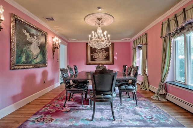 dining room with crown molding and hardwood / wood-style flooring