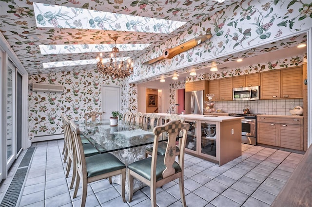 tiled dining space featuring an inviting chandelier, a baseboard heating unit, and a wall mounted air conditioner