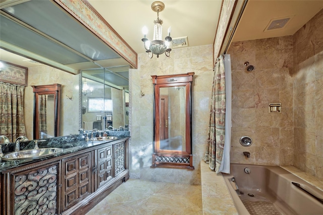 bathroom featuring tile walls, vanity, tiled shower / bath combo, and an inviting chandelier