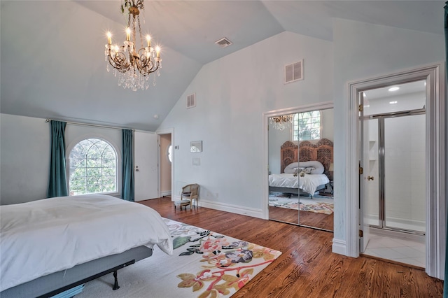 bedroom featuring hardwood / wood-style flooring, high vaulted ceiling, and a notable chandelier