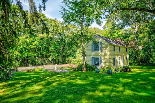 rear view of house featuring a lawn